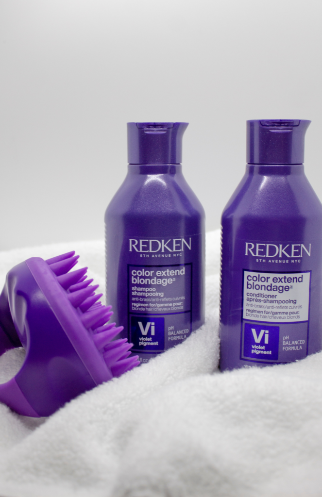 Display packaging of REDKEN Color Extend Shampoo and Conditioner bottles, accompanied by a purple Wet Brush!