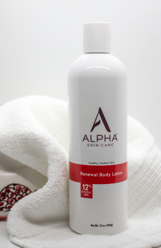 An elegantly displayed bottle of the Alpha Skin Care Renewal Body Lotion with 12% Glycolic Acid, a winter body moisturizer enriched with active ingredients.