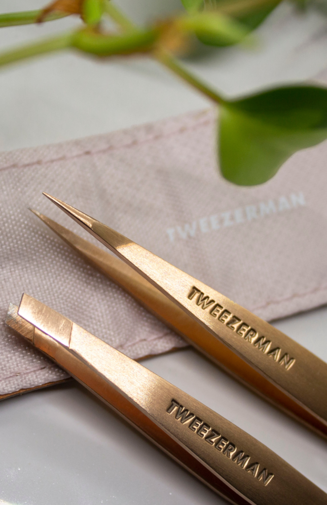 Display of a perfect pair of Tweezerman Tweezers. Petite Tweeze Set Rose Gold and case.