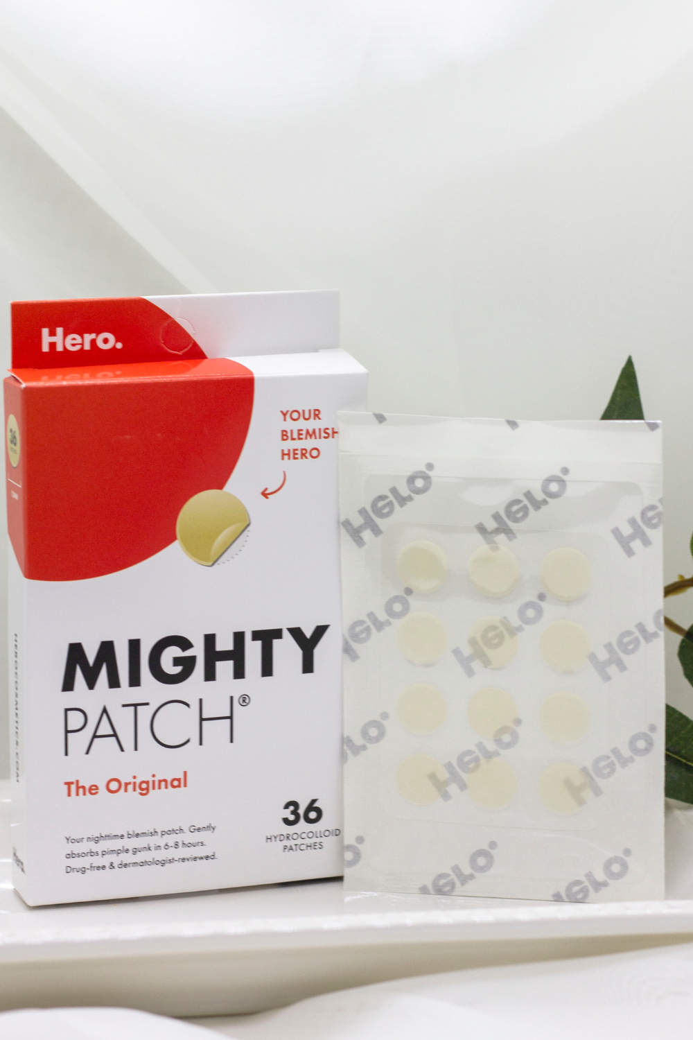 Featured: Hero Cosmetics' Mighty Patch Original packaging alongside a sheet of small hydrocolloid patches.