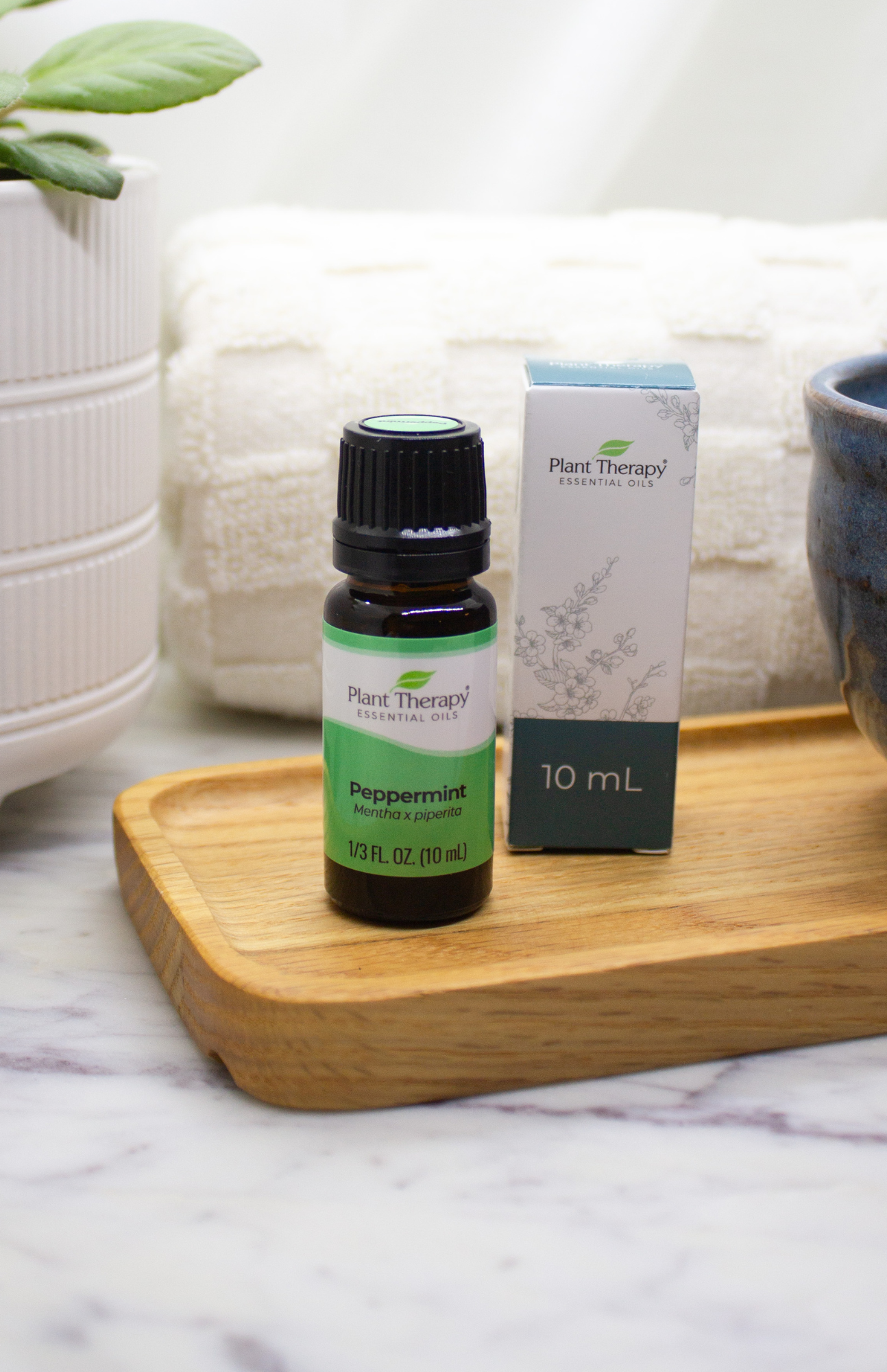 Image showcasing organic peppermint essential oil packaging for a refreshing closet experience, highlighting its aesthetic and eco-friendly design.