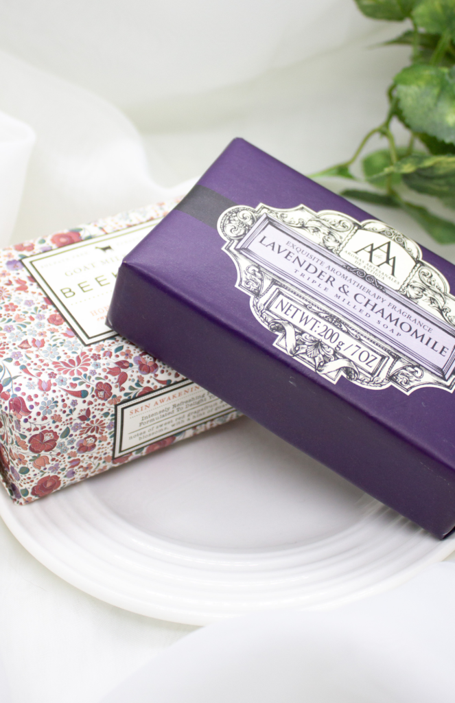 Image of beautifully wrapped soaps in their original packaging, including lavender & chamomile and goat milk soap from Beekman Honeyed Grapefruit enriched with guava leaf extract. Enhance the aromatic charm of your closet with these affordable yet effective choices, perfect for adding freshness to your wardrobe care routine.