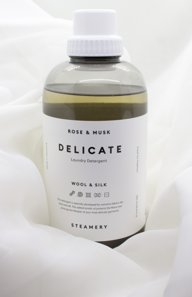 A bottle of Steamery products, a renowned Scandinavian clothing care brand, featuring my favorite blend of rose and musk delicate liquid laundry detergent. Displayed elegantly against a white neutral background.