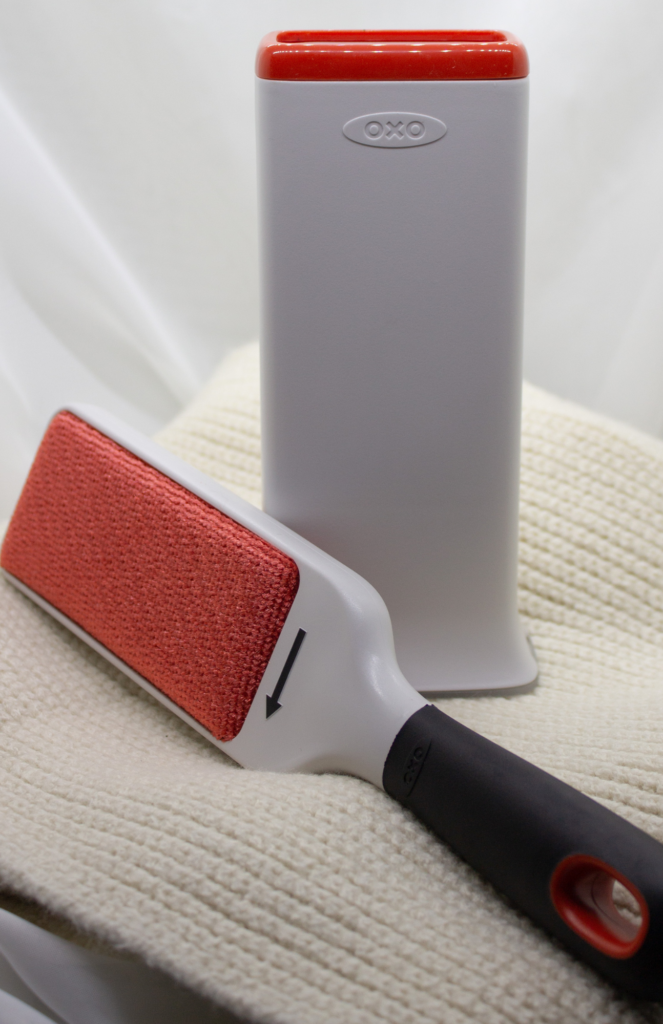 OXO Good Grips lint brush with a self-cleaning base for removing lint and pet hair.