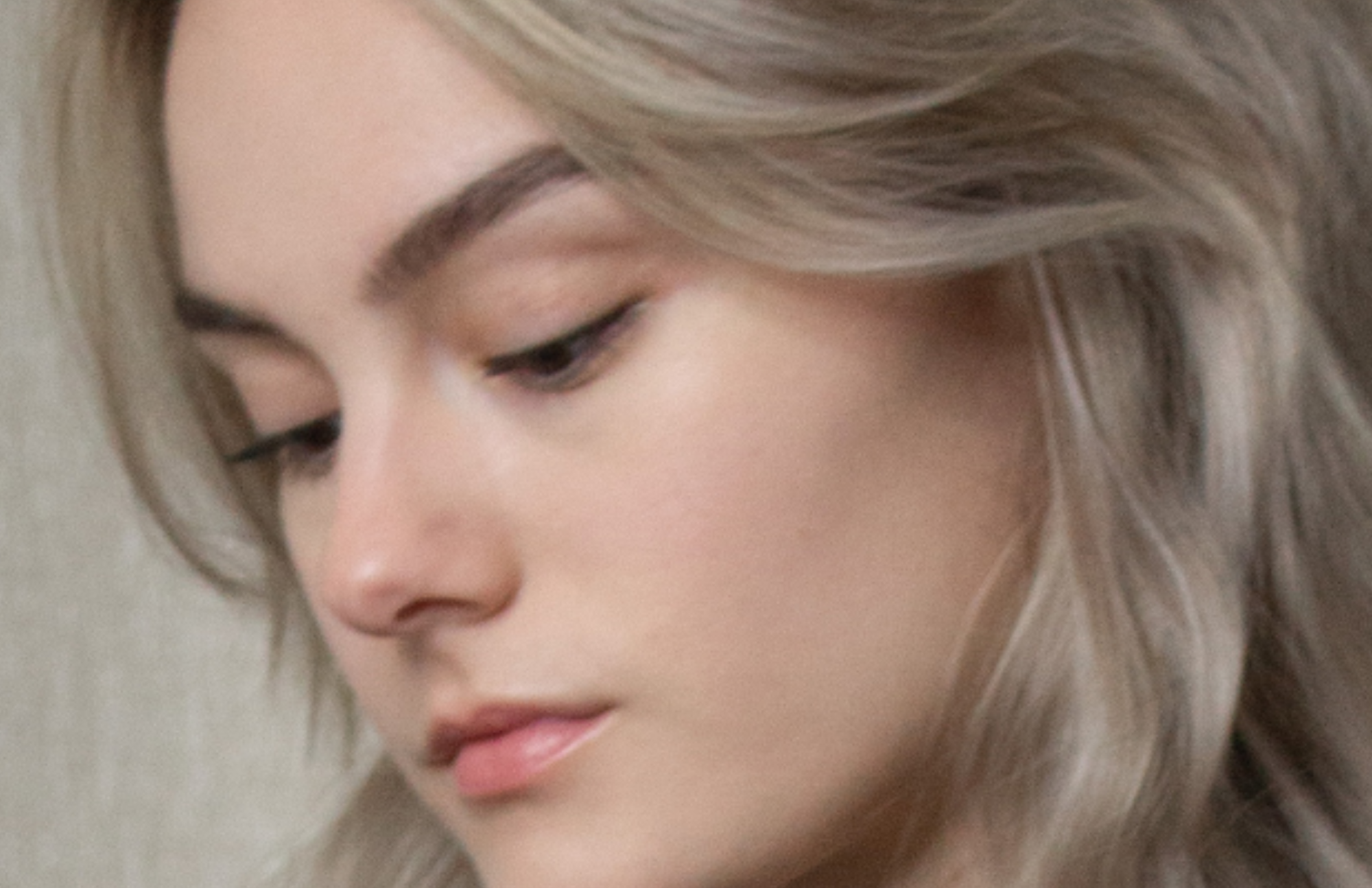 Close-up of content creator highlighting her under-eye area, emphasizing skincare results.